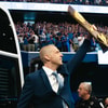 Mark Pope steps off the bus holding the 1996 national championship trophy at his introductory press conference - Aaron Perkins, Kentucky Sports Radio