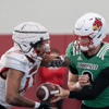 Louisville football quarterback Tyler Shough (9) and running back Peny Boone (13) run drills during spring practice on Saturday, March 23, 2024 at the Trager practice facility in Louisville, Ky.