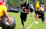 Jacob Peeler (back) coaches Tavorus Jones through a drill
