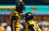 West Virginia defensive back Jordan Scruggs celebrates the pass breakup