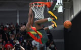 Mar 30, 2026; Goodyear, AZ, USA; Oliviyah Edwards hangs upside down from the rim as she celebrates after dunking the ball during the McDonalds All American Jam Fest at Millennium High School. Mandatory Credit: Mark J. Rebilas-Imagn Images