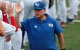 Kansas Jayhawks coach Dan Fitzgerald high fives players before taking on Oklahoma Sooners during the NCAA Lawrence Super