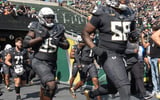 Oregons offensive lineman Ziyare Addison, right, takes the field against Oregon State.