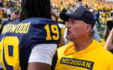 Michigan quarterback Bryce Underwood (19) talks to head coach Kyle Whittingham to celebrate 17-10 win over Oklahoma at Michigan