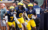 Michigan Wolverines football defenders Chris Bracy, Jyaire Hill and Troy Bowles celebrate a turnover against Oklahoma. (Photo by USA TODAY Network via Reuters Connect)