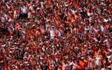 Oklahoma State fans cheer in the first half of the college football game between the Oklahoma State Cowboys and the Oregon Ducks