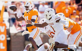 Sep 26, 2026; Knoxville, Tennessee, USA; Tennessee quarterback Faizon Brandon (11) is swarmed by Texas defenders during a college football game between Tennessee and Texas at Neyland Stadium in Knoxville, Tenn. on Sept. 26, 2026. Mandatory Credit: Brianna Paciorka-USA TODAY Network via Imagn Images