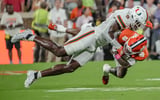 Miami Hurricanes linebacker Chase Smith (9) tackles Clemson receiver Tyler Brown (6) during the first quarter at Memorial