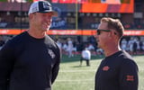 UCF head coach Scott Frost and OSU head coach Eric Morris meet on the field before an NCAA football game between the Oklahoma