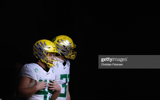 GLENDALE, ARIZONA - JANUARY 02: Place kicker Camden Lewis #49 and punter Race Mahlum #31 of the Oregon Ducks walk onto the field before PlayStation Fiesta Bowl against the Iowa State Cyclones at State Farm Stadium on January 02, 2021 in Glendale, Arizona.