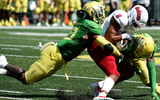 EUGENE, OREGON - SEPTEMBER 04: Linebacker Justin Flowe #10 and cornerback Dontae Manning #8 of the Oregon Ducks bring down wide receiver Ty Jones #8 of the Fresno State Bulldogs during the third quarter of the game at Autzen Stadium on September 04, 2021