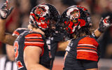 Logan Kendall #32 of the Utah Utes celebrates with teammate Cameron Rising #7 after he scored a touchdown against the USC Trojans during the second half of their game October 15, 2022 Rice-Eccles Stadium in Salt Lake City Utah. The Utes wore hand painted