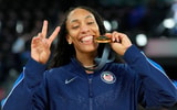 A'Ja Wilson (9) celebrates with the gold medal after defeating France in the women's gold medal game during the Paris 2024 Olympic Summer Games at Accor Arena. Mandatory Credit: Kyle Terada-USA TODAY Sports