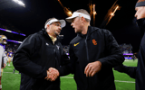 Washington Huskies head coach Jedd Fisch, left, shakes hands with USC Trojans head coach Lincoln Riley following a Washington victory at Alaska Airlines Field at Husky Stadium