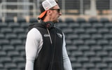 Oregon State co-offensive coordinator and quarterbacks coach Mitch Dahlen runs drills during fall camp at Reser Stadium on