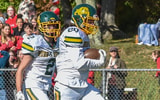 Burr and Burton's Andrew Maneggia runs to paydirt after a short pass during the Bulldogs' game vs the CVU Redhawks on Saturday
