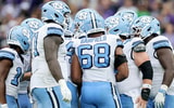 UNCGENFB-huddle-offensive-line