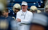 Akron Zips football coach Joe Moorhead leads the team through warmups before the season opener against Wyoming on Aug. 28, 2025,