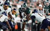 Michigan State running back Cam Edwards (0) runs against Toledo cornerback Cam Jones (1) during the first half at Spartan Stadium in East Lansing on Friday, Sept. 4, 2026. - Junfu Han, USA TODAY Sports