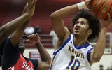 Bremertonís Jalen Davis (10) goes up for a basket over Rentonís Nate Omar (4) and Suhail Abdulmumin (34) on Saturday, Feb. 28 at