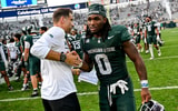 Michigan State’s Cam Edwards, right, shakes hands with defensive coordinator Joe Rossi after defeating Eastern Michigan on Saturday, Sept. 12, 2026, at Spartan Stadium in East Lansing. -Nick King/Lansing State Journal / USA TODAY NETWORK via Imagn Images