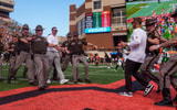 Oregon head coach Dan Lanning, center left, and Oklahoma State head coach Eric Morris approach to shake hands as the Oregon