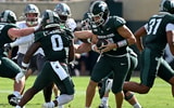 Sep 12, 2026; East Lansing, Michigan, USA; Michigan State Spartans quarterback Alessio Milivojevic (11) moves in the backfield against the Eastern Michigan Eagles during the first quarter at Spartan Stadium. Photo Credit: Dale Young-Imagn Images