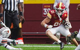 Iowa State punt returner Aiden Flora (21) breaks a tackle attempt by Bowling Green Falcons special team player Nick Sawyer (18)