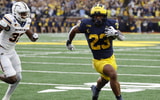 Sep 19, 2026; Ann Arbor, Michigan, USA; Michigan Wolverines running back Jordan Marshall (23) scores a touchdown with Texas El Paso Miners defensive back Adarius Hutchinson (32) defending during the third quarter at Michigan Stadium. Mandatory Credit: Rick Osentoski-Imagn Images