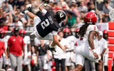Vanderbilt quarterback Jared Curtis (2) leaps over NC State defensive back Ty White (10) during the second quarter at FirstBank