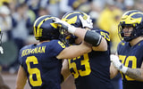 Michigan Wolverines football wide receiver JJ Buchanan celebrates with Jake Guarnera and Brady Norton. (Photo by IMAGN IMAGES via Reuters Connect)