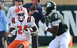 Illinois Fighting Illini running back Javari Barnett (24) runs upfield before being forced out of bounds by Michigan State Spartans defensive back Devin Vaught (2) during the first quarter at Spartan Stadium. - Dale Young, USA TODAY Sports