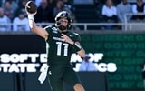 Oct 17, 2026; East Lansing, Michigan, USA; Michigan State Spartans quarterback Alessio Milivojevic (11) leaps and throws against the Northwestern Wildcats during the first quarter at Spartan Stadium. (Photo  Credit: Dale Young-Imagn Images)