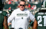 Michigan State’s head coach Pat Fitzgerald, center, talks with Jaziun Patterson, left, and Marvis Parrish before the football game against Nebraska on Saturday, Sept. 26, 2026, in East Lansing. (Photo credit: Nick King/Lansing State Journal / USA TODAY NETWORK via Imagn Images)