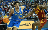 LOS ANGELES, CA - MARCH 05: Johnny Juzang #3 of the UCLA Bruins is defended by Chevez Goodwin #1 of the USC Trojans as he drives to the basket in the first half against the USC Trojans at UCLA Pauley Pavilion on March 5, 2022 in Los Angeles, California. 