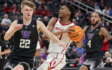 LAS VEGAS, NEVADA - MARCH 10: Reese Dixon-Waters #21 of the USC Trojans drives to the basket against Cole Bajema #22 and PJ Fuller #4 of the Washington Huskies during the Pac-12 Conference basketball tournament quarterfinals at T-Mobile Arena on March 10,