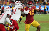 USC Trojans defensive lineman Tuli Tuipulotu (49) chases the running back while being blocked by Fresno State Bulldogs defensive lineman Charles Remlinger (51) during an NCAA football game against the Bulldogs played on September 17, 2022 at the Los Angel