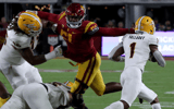 Arizona State running back X Valladay slips past the grasp of USC defensive lineman Solomon Byrd in the first quarter at the Los Angeles Memorial Coliseum on Saturday night, Oct. 1, 2022. (Luis Sinco / Los Angeles Times via Getty Images)