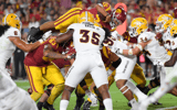 Running back Travis Dye #26 of the USC Trojans goes airborne as he scores a touchdown against Kyle Soelle #34 of the Arizona State Sun Devils during the second half at United Airlines Field at the Los Angeles Memorial Coliseum on October 1, 2022 in Los An