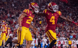 Travis Dye and Mario Williams celebrate a USC touchdown against Arizona State