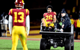 Quarterback Caleb Williams #13 of the USC Trojans looks at running back Travis Dye #26 of the USC Trojans as he is carted off the field after an injury against the Colorado Buffaloes in the first half of a NCAA football game at the Los Angeles Memorial Co