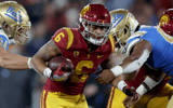 Austin Jones #6 of the USC Trojans runs the ball against the UCLA Bruins during the second quarter in the game at Rose Bowl on November 19, 2022 in Pasadena, California. (Photo by Harry How/Getty Images)