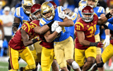 Defensive lineman Tuli Tuipulotu #49 of the USC Trojans tackles running back Zach Charbonnet #24 of the UCLA Bruins in the second half of a NCAA Football game at the Rose Bowl in Pasadena on Saturday, November 19, 2022. USC Trojans won 48-45. (Photo by Ke