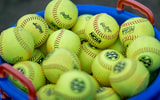 SEC softballs in a bucket