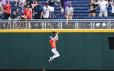 florida-baseJun 21, 2023; Omaha, NE, USA; Florida Gators center fielder Michael Robertson (11) makes a game saving catch against the fence for the last out against the TCU Horned Frogs in the ninth inning at Charles Schwab Field Omaha. (Steven Branscombe-USA TODAY Sports)ball-michael-robertson
