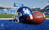 Football in front of a Kentucky helmer at Kroger Field