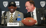 Colorado head coach Deion Sanders with athletic director Rick George