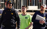 Michigan head coach Jim Harbaugh next to analyst Connor Stalions