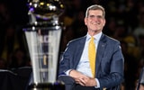 Jim Harbaugh looks on during Michigan's national championship celebration.