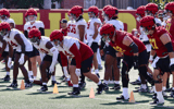 The USC Trojans warm up before the first practice of 2024 spring ball